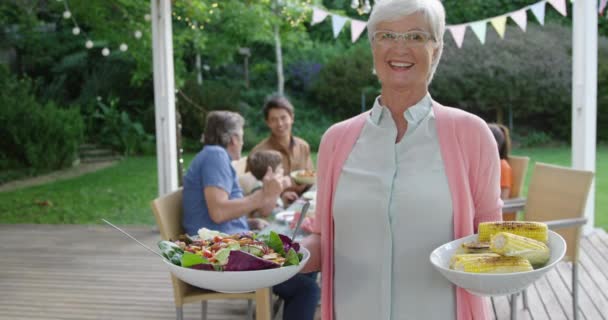 Porträtt Leende Äldre Kaukasiska Kvinna Stående Håller Tallrikar Med Mat — Stockvideo