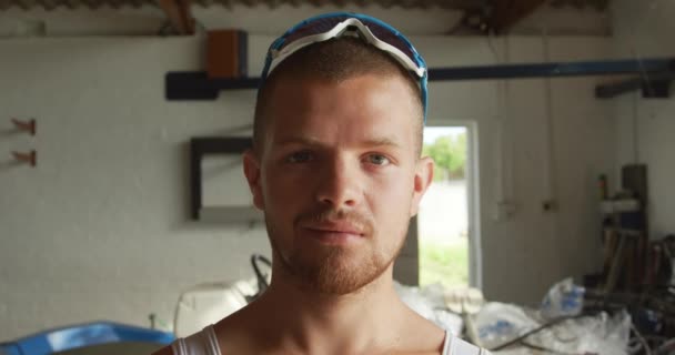 Portrait Confident Caucasian Male Rower Standing Boathouse Looking Camera Sunny — Stock Video