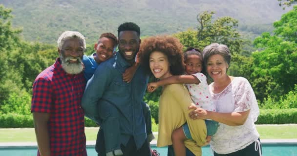 Multi Generation Mixed Race Family Enjoying Time Garden Pool Standing — Stock Video