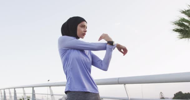 Side View Mixed Race Woman Wearing Sportswear Hijab Exercising Outdoors — Stock Video