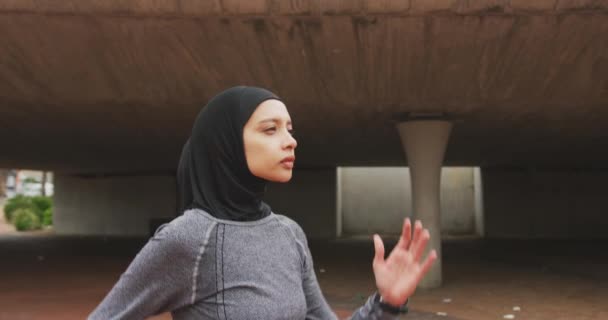 Side View Mixed Race Woman Wearing Sportswear Hijab Exercising Outdoors — Stock Video