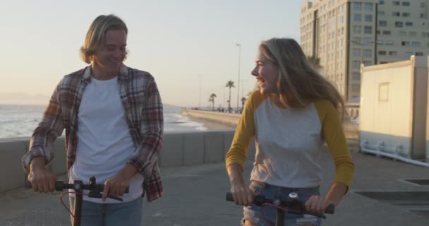 Caucasian Couple Beach Sunny Day Enjoying Time Together Riding Scooters — Stock Video