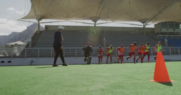 민족으로 구성된 선수들 훈련을 코치와 경기장에서 날느린 동작으로 달리는 — 비디오