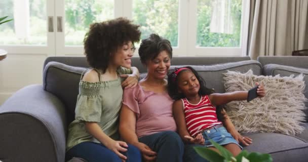 Multi Generation Mixed Race Family Sitting Couch Interacting Using Smartphone — Stock Video