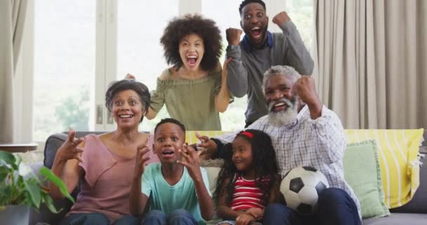 多代混血种族的家庭 在科罗纳韦病毒肆虐 慢动作期间 享受着呆在家里 坐在沙发上 看电视游戏 社交疏远和自我隔离的快乐时光 — 图库视频影像