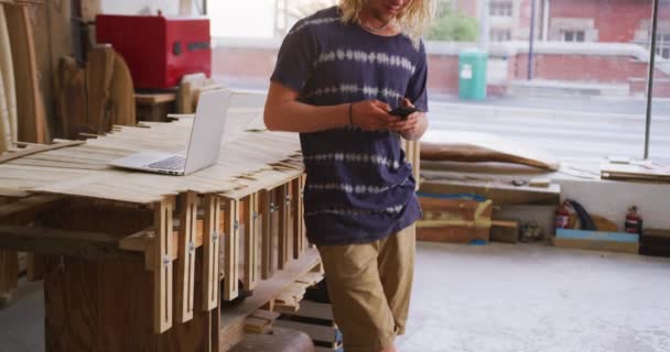 Blanke Mannelijke Surfplankenmaker Met Lang Blond Haar Met Blauw Shirt — Stockvideo