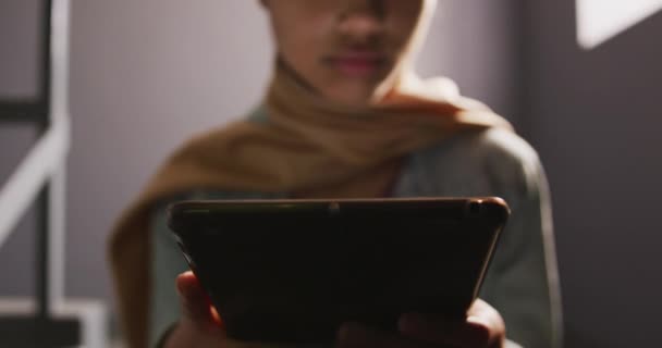 Kütüphanede Bej Başörtüsü Takan Merdivenlerde Oturup Tablet Kullanan Yavaş Çekimde — Stok video