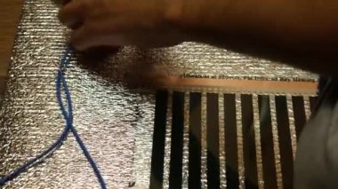 Kabloyla bağlanıyor. Elektrik işliyor. Evin zeminine ısıtma sistemi kurulmuş. İnsan kabloları bağlar.