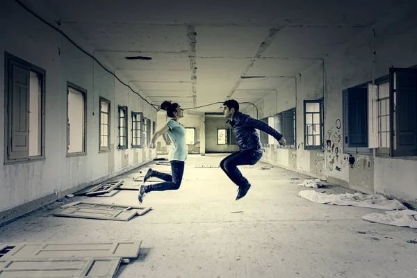 Couple jumping interior — Stock Photo, Image
