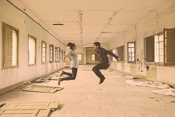 Couple jumping interior — Stock Photo, Image