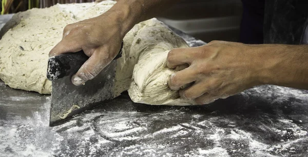 Man kneading bread