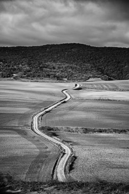 Dağları, mavi gökyüzünü, manzarası ve doğası olan kırsalda bir yol.