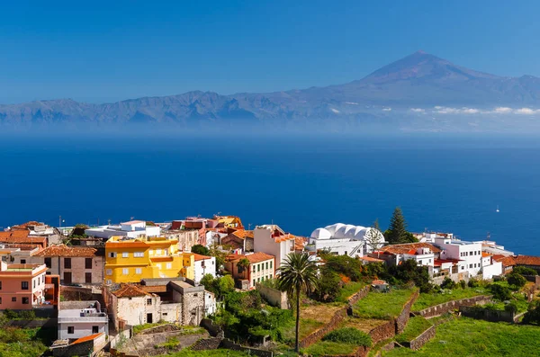 View Agulo town buildings banana plantation Tenerife island Teide volcano background, La Gomera, Canary Islands