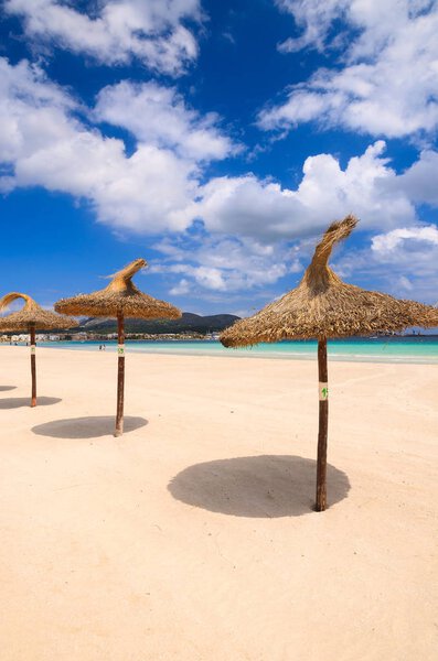 Umbrellas on sandy Alcudia beach, Majorca island, Spain