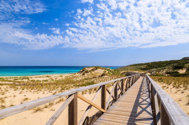 Wooden footbridge to Cala Sa Mesquida beach, Majorca island clipart
