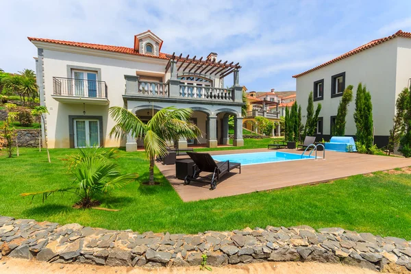 MADEIRA ISLAND, PORTUGAL - AUG 27, 2013: swimming pool of luxury villa in hotel on coast of Atlantic Ocean. Madeira island is famous for best hotels in Portugal and for climate of eternal spring.