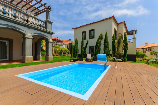 MADEIRA ISLAND, PORTUGAL - AUG 27, 2013: Swimming pool of luxury villa on coast of Atlantic Ocean in seaside hotel, Madeira island, Portugal.