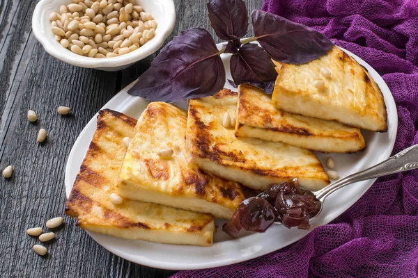 Grilled cheese, served with onion jam and Siberian pine nuts