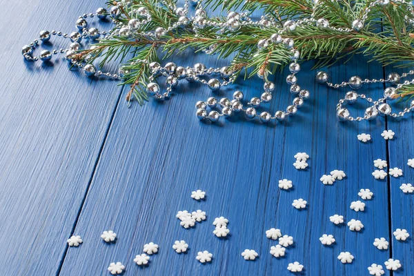 Joulutausta kuusen oksilla, helmillä ja lumihiutaleilla — kuvapankkivalokuva