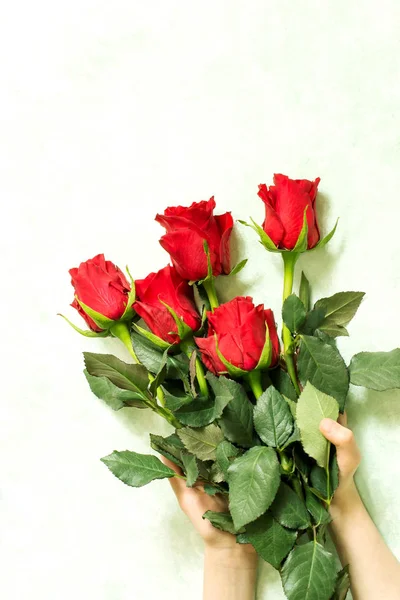 Bouquet of red roses in female hands — Stock Photo, Image