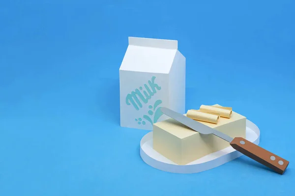 Manteiga de papel no prato e leite na caixa — Fotografia de Stock