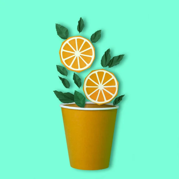 Paper slices of orange and mint leaves fall in paper cup — 스톡 사진