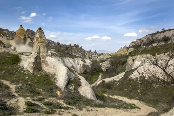 A view from the base of Pigeon Valley at Uchisar in the Cappadocia region of Turkey. Abandoned ancient fairy chimney cave homes can be seen in the distance.