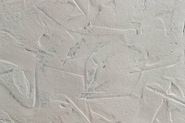 Soyut desenli arka plan: açık gri macun. Taştan yüzey taklidi. Duvar deseni olarak pürüzlü doku