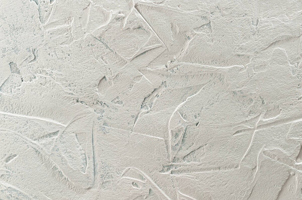 Abstract textured background: light gray putty. Imitation of surface of stone. Rough texture as wall pattern