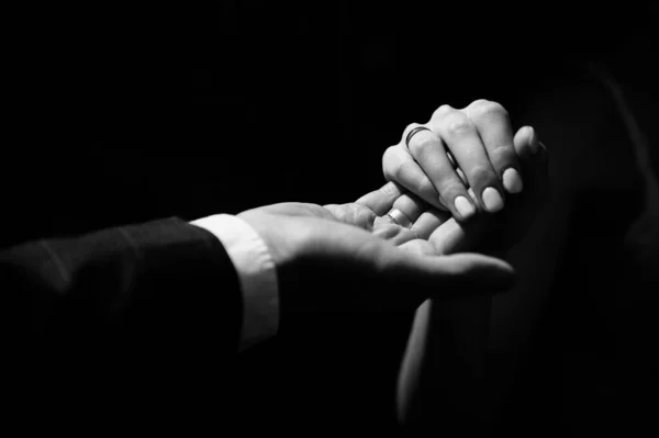 Male hand holds a female hand providing assistance and support. Newlyweds or couple in love — Stock Photo, Image