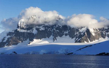 Icebergs of various forms and sizes. clipart