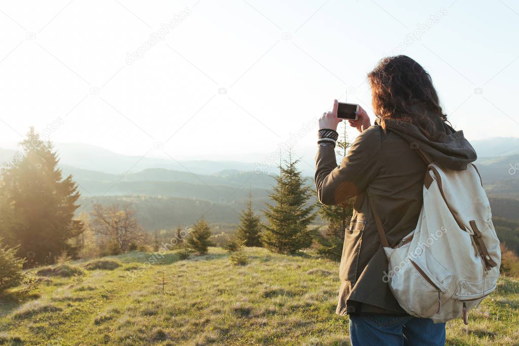 woman with backpack take photo