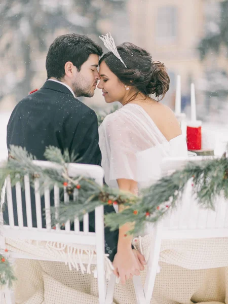 Winter wedding outdoor. Beautiful couple smiling and kissing
