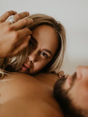 Güzel bir çift yatakta öpüşüyor.