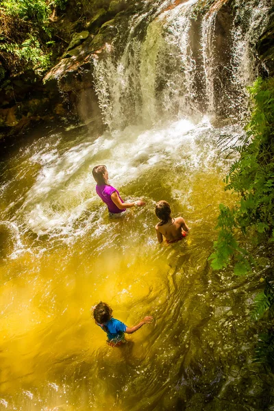 Brother and sisters swimming in thermal river — Stock Photo, Image