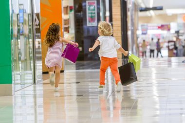 Kids shopping. cute little girl and boy on shopping. clipart