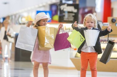 Kids shopping. cute little girl and boy on shopping. clipart