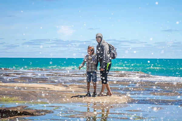 Familie staande op Muriwai strand — Stockfoto