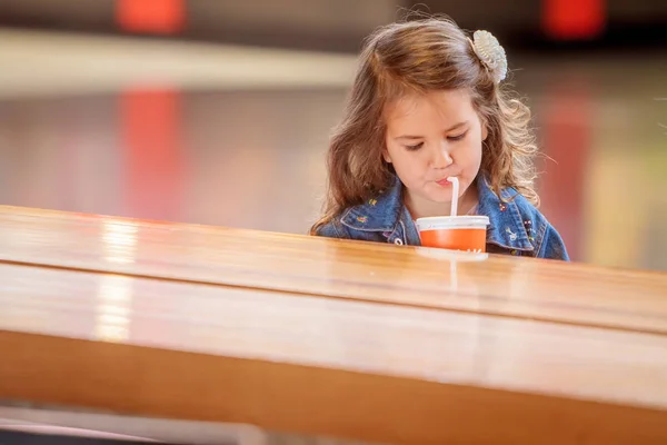 Tjej dricka juice i ett café — Stockfoto