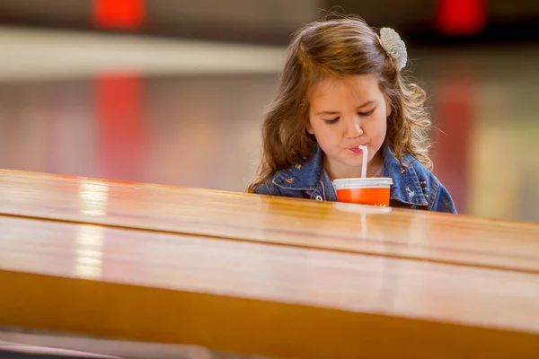 Young happy girl drinking juice — Stock Photo, Image