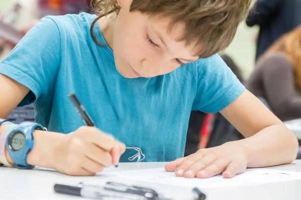 Boy drawing on white paper — Stock Photo, Image