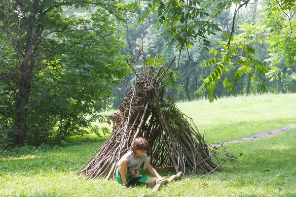 木の棒の家の隣に遊ぶ子供たち — ストック写真