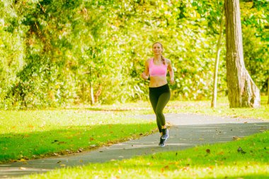 Runner jogging in summer park clipart