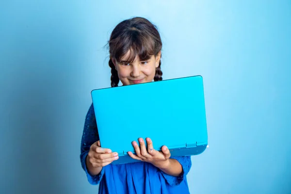 带笔记本电脑的小女孩室内肖像画 孤立的演播室拍摄 在线教育 — 图库照片