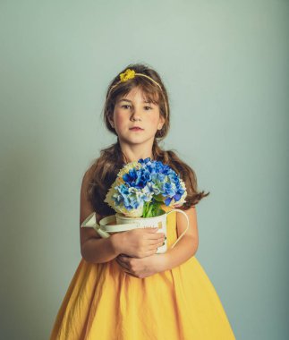 Sade arka planda izole edilmiş çiçeklerle çocuk gril 'inin kapalı stüdyo portresi