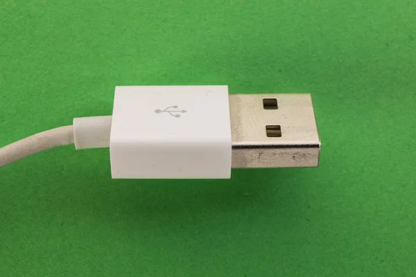 White usb cable on a green background