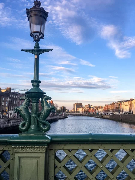 Trinity College Dublin/Ireland Republic - May 15, 2019: Tourist walk past wall surrounding Trinity College in Dublin, Ireland.