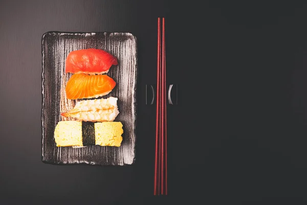 Ensemble de sushis savoureux sur fond noir . — Photo