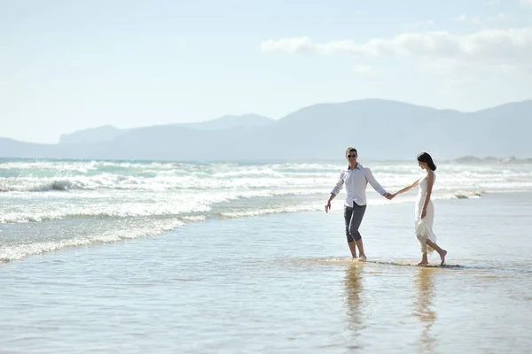Couple walking holding hands on the beach of Sperlonga, Italy — Stock Photo, Image