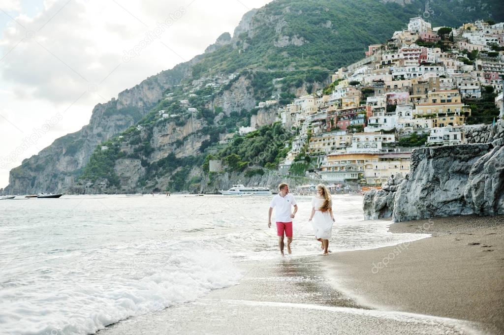 Young couple on the beach of Positano, Amalfi Coast, Italy
